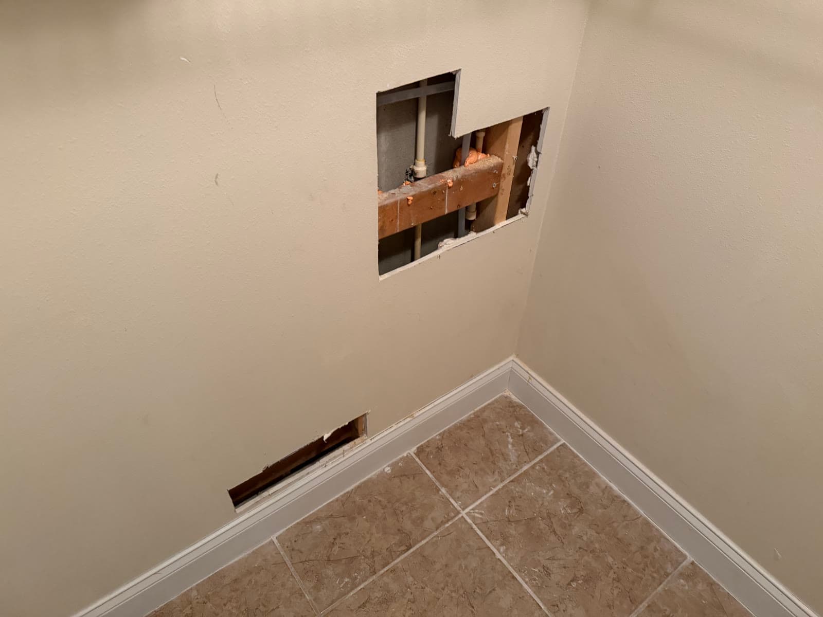 Bathroom wall opening before drywall repair after repiping in Melbourne FL