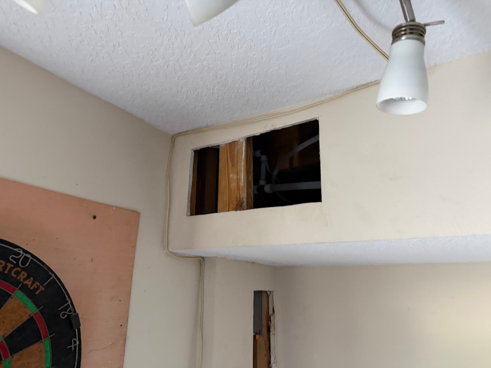 Wall plumbing opening before drywall repair after repiping in Melbourne FL