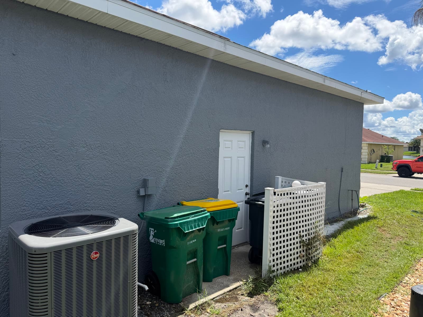 Back door and exterior stucco wall after painting and repair work