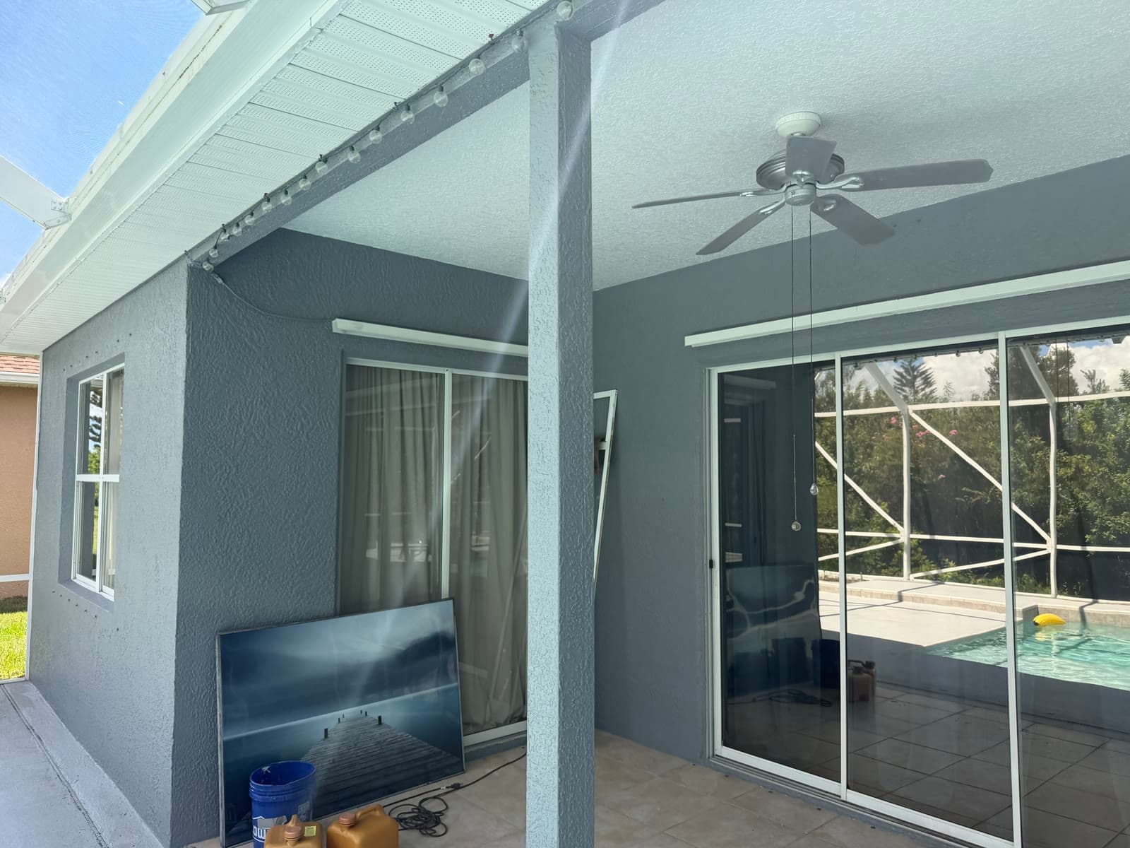 Back patio wall and sliding door area after exterior painting and repairs