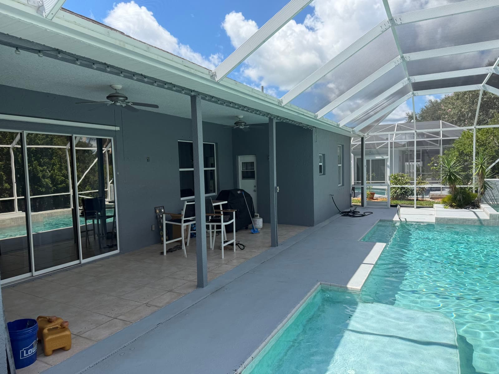 Pool patio exterior walls after pressure washing and painting in Viera Suntree FL