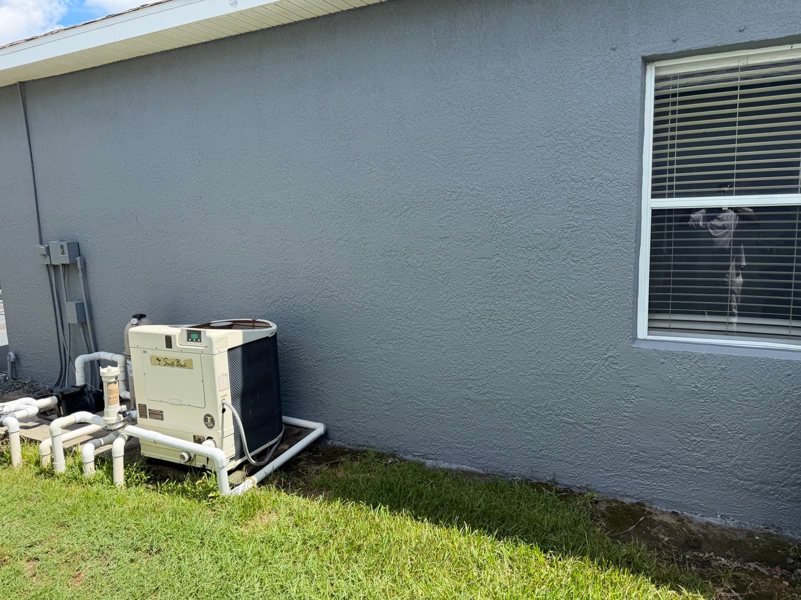 Stucco wall repair and exterior paint finish near pool equipment