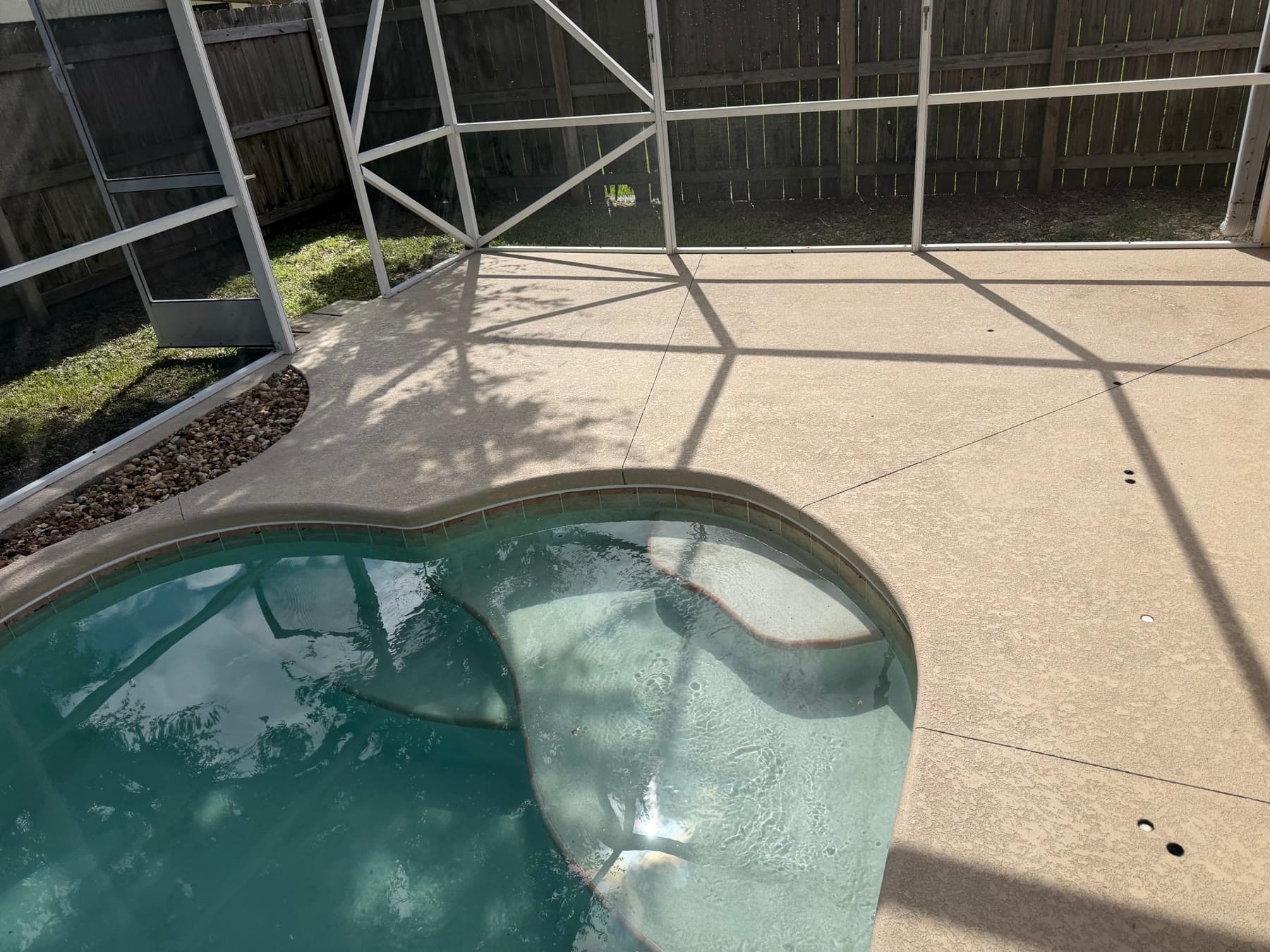 Screened pool deck before exterior maintenance at a Palm Bay FL home
