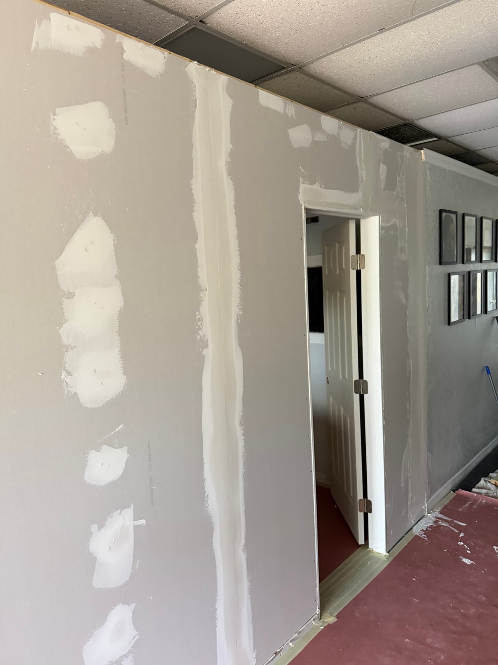 Drywall seams and fasteners being finished on a new stylist room in Palm Bay FL
