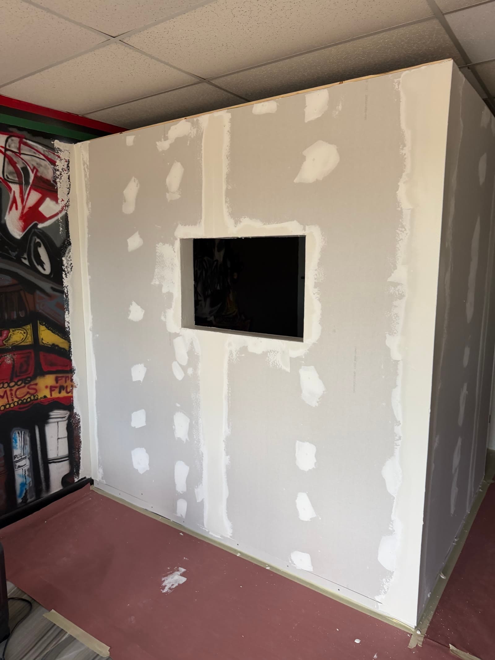 Drywall installed around the new interior window during the Exodus Barbershop build-out
