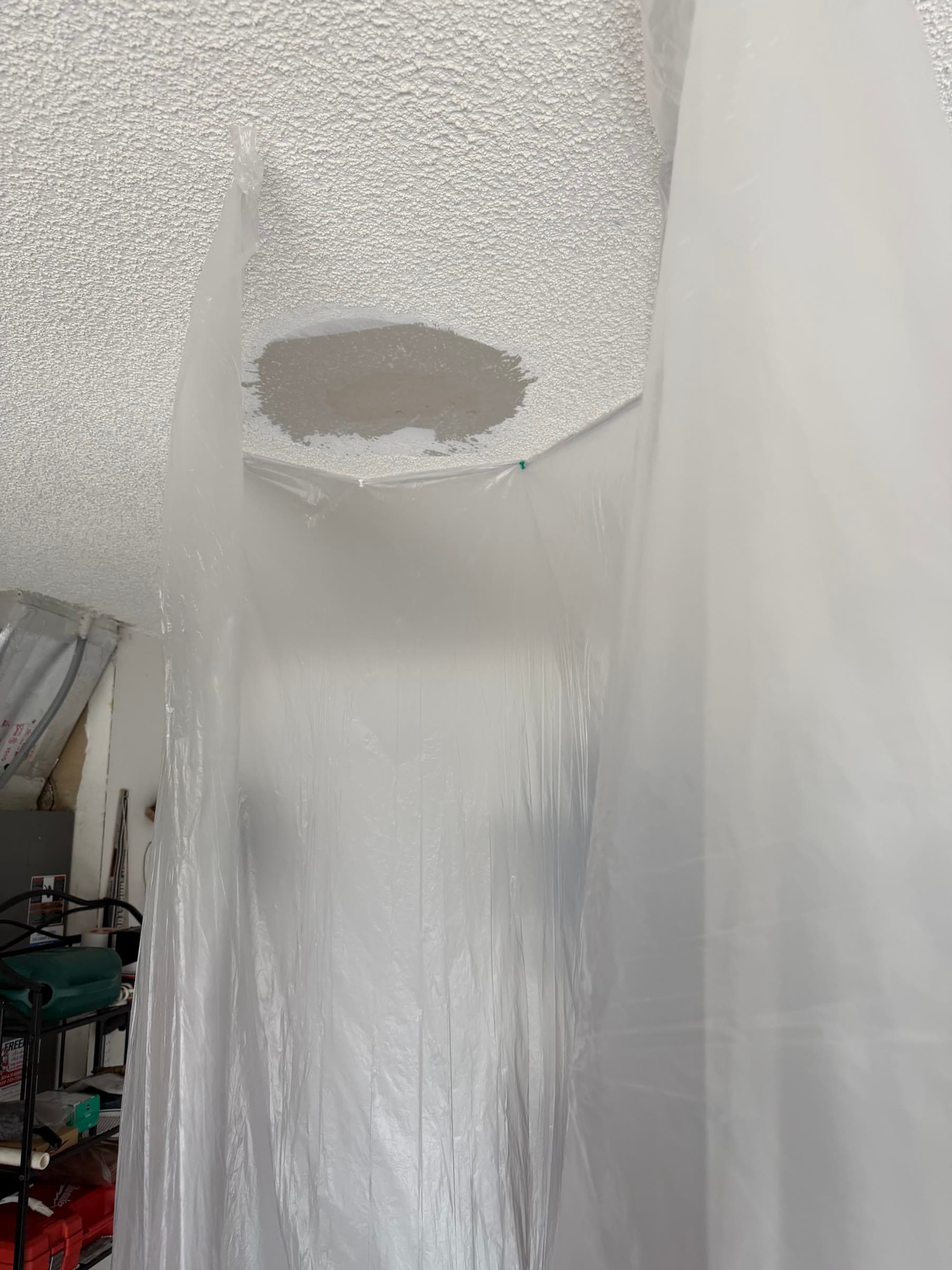 Damaged garage ceiling patch before texture blending in Melbourne FL