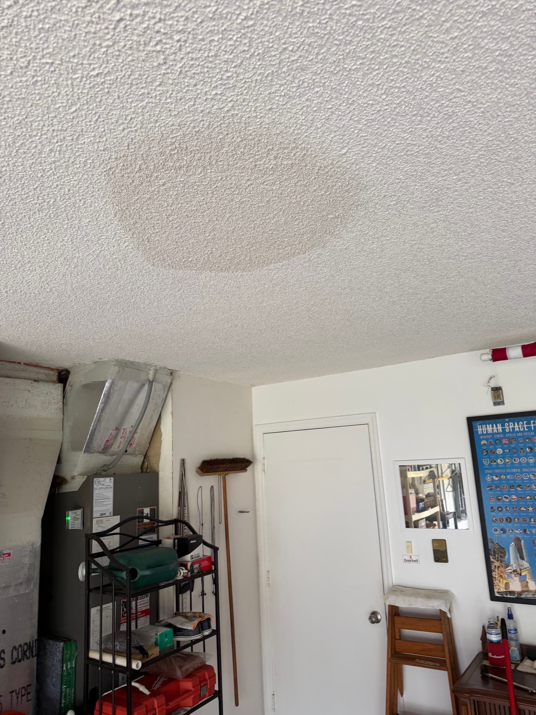 Textured garage ceiling damage before leak repair in Melbourne FL