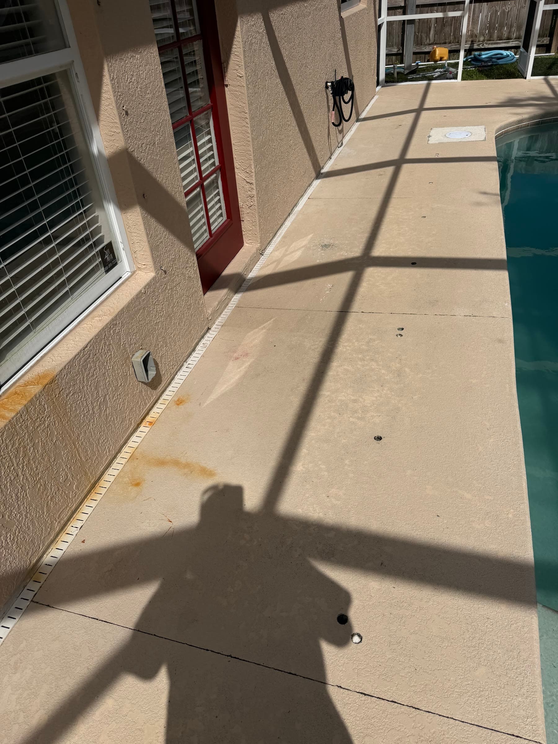 Pool deck beside the house before exterior maintenance in Palm Bay FL
