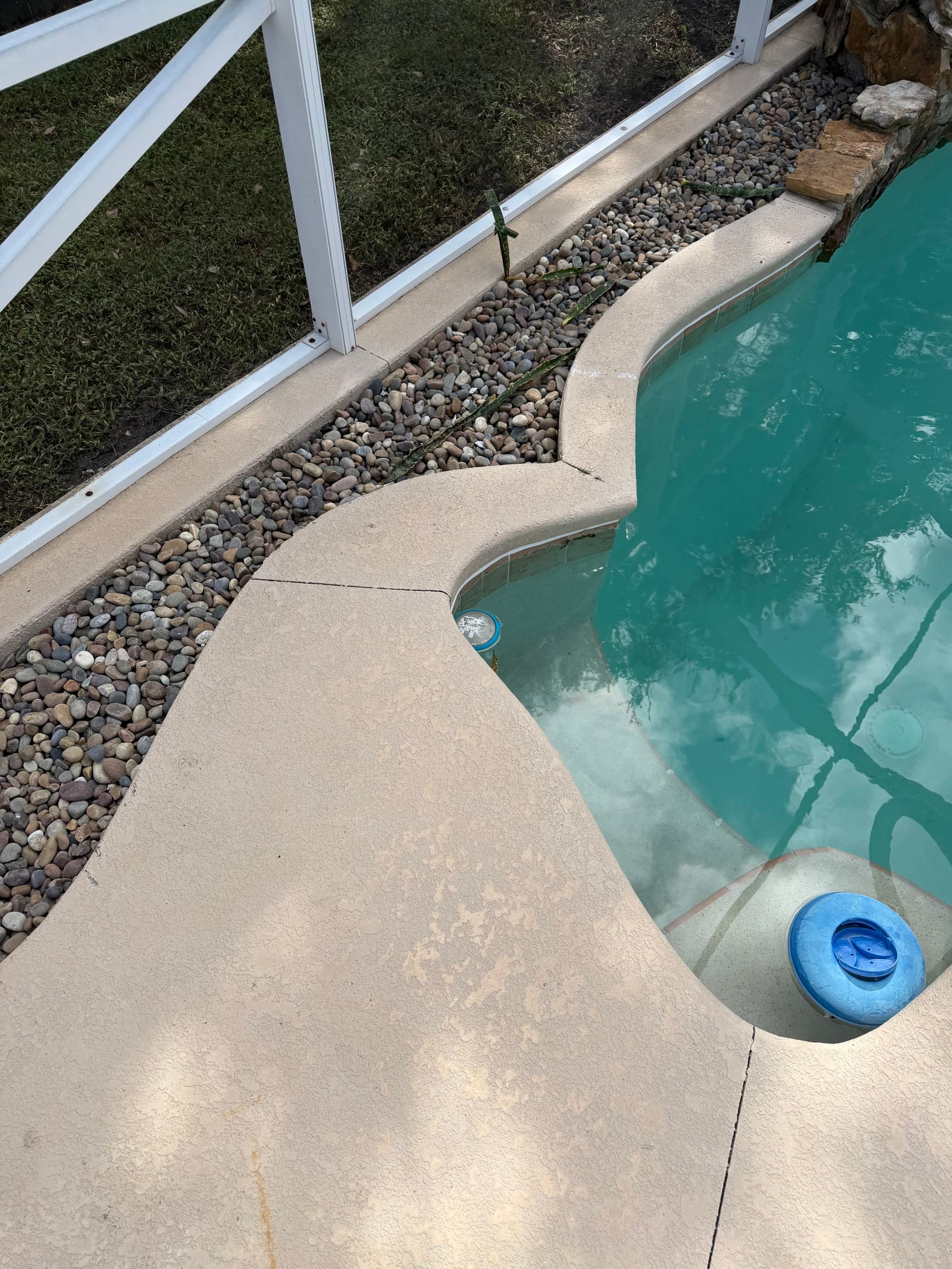Spa-edge pool deck showing surface wear before maintenance in Palm Bay FL